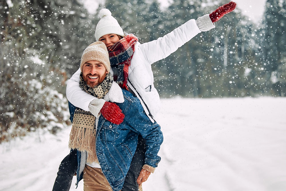 Женщина и мужчина на прогулке в зимнем лесу