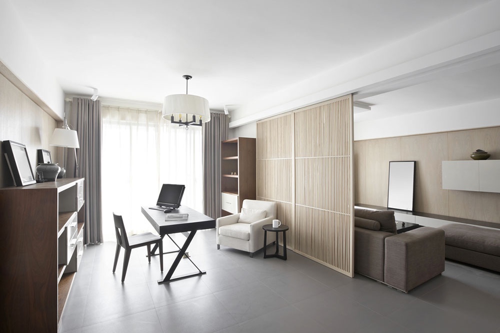 Гостиная комната, где рабочее место отделено от зоны отдыха светлой реечной ширмой.