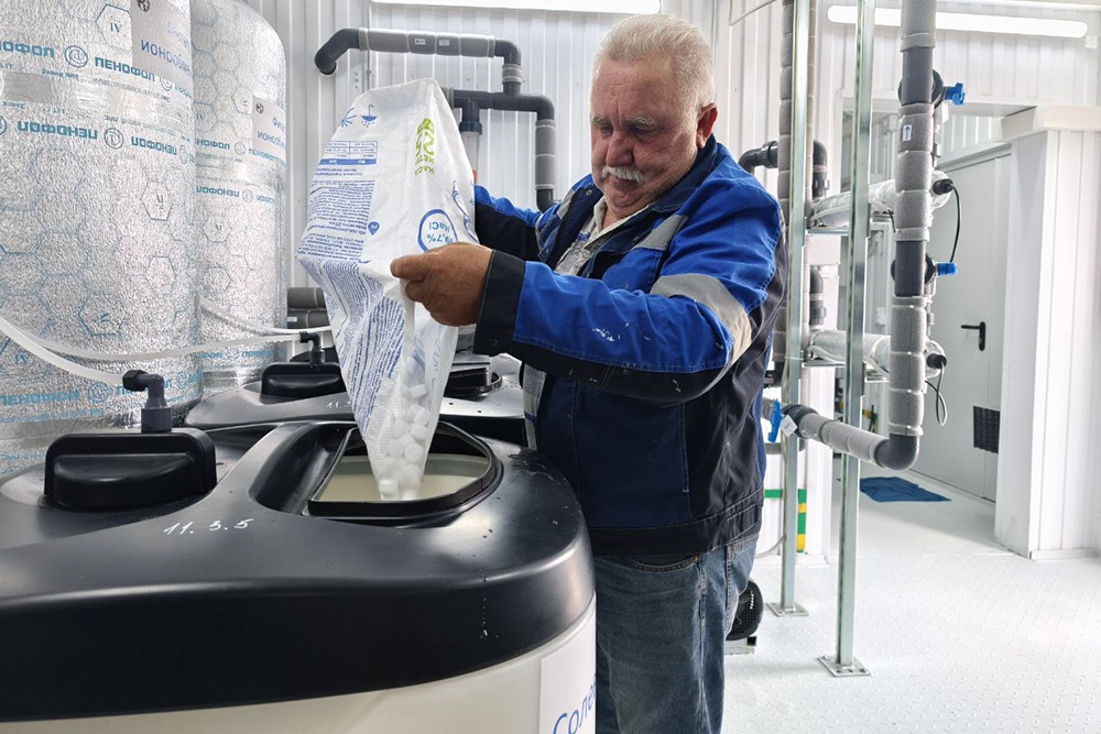 Оператор Александр Пырьев засыпает соль для очистки фильтров и следит за показаниями датчиков - остальную работу выполняет автоматика.