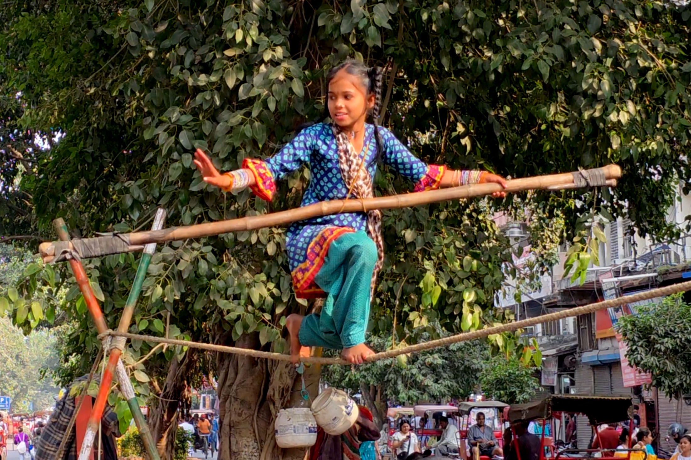 Девочка или мальчик на канате - повседневная деталь рынка Чандни Чоук.