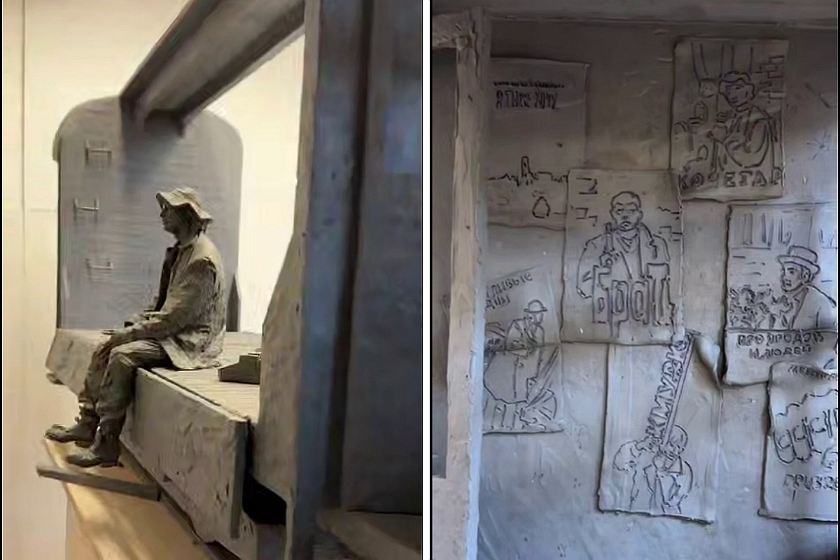 Алексей Балабанов сидит на полу трамвая, интерьер которого украшают афиши из его фильмов.